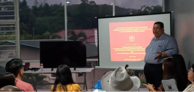 Shari Jeffri presenting beside a projected document