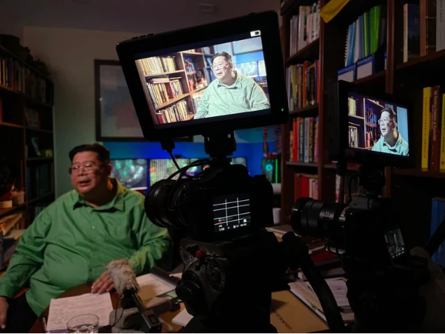 A camera monitor frames Shari Jeffri during recording