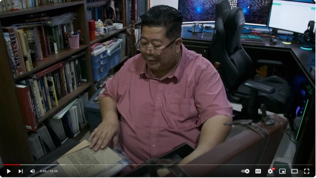 Shari Jeffri examining documents in a still from 85 Ribu