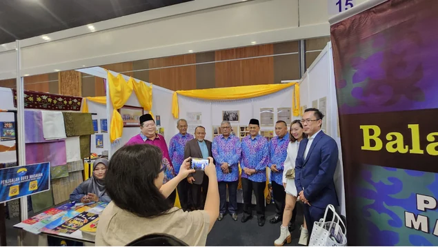Guests and media gathered around the exhibition