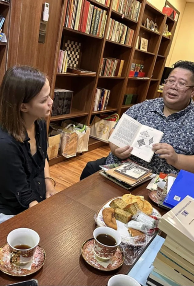 Visitors discussing records at a table