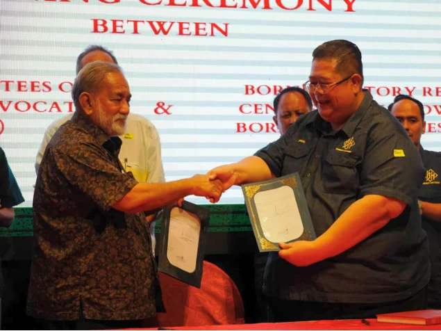 A handshake and presentation of the signed agreement
