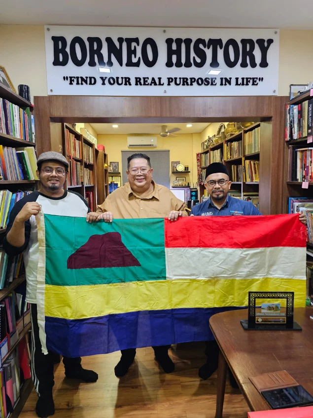 The visiting group beside the gallery flag