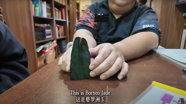 An object being examined in a still from the interview