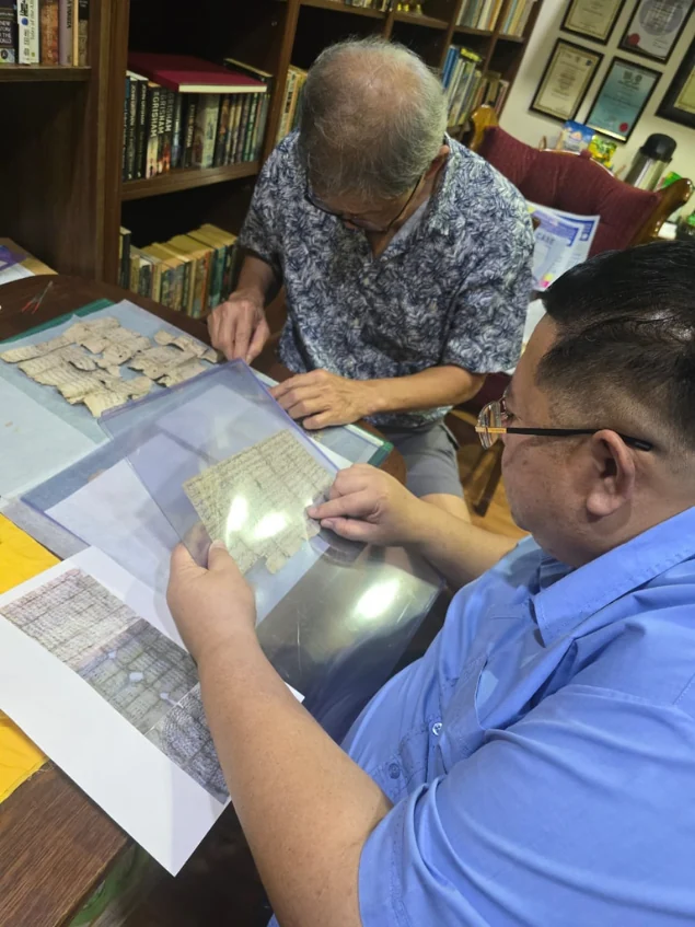 Shari Jeffri and Alex Teoh with a manuscript