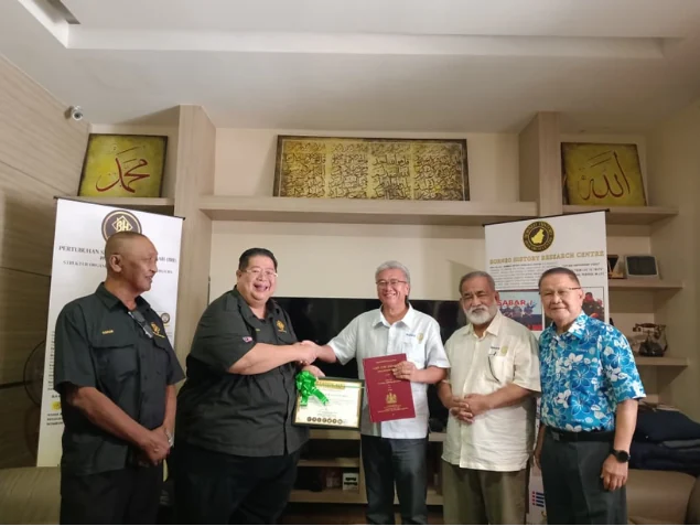 Presenting historical volumes during the Rotary Club visit